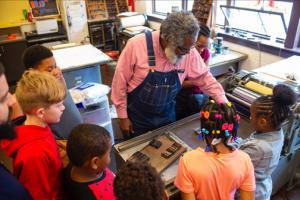 Amos Paul Kennedy Jr demonstrating to children